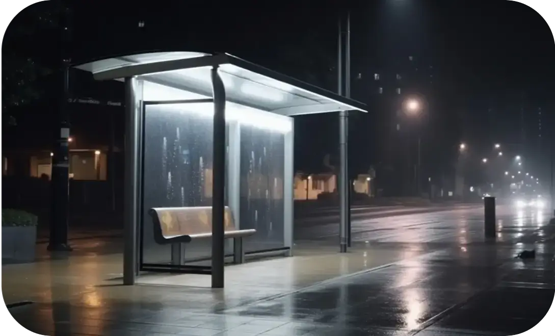 Modern bus shelter with stainless steel frame and integrated solar panels.