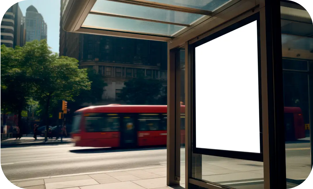 Bus shelter with a glass canopy and metal support structure.