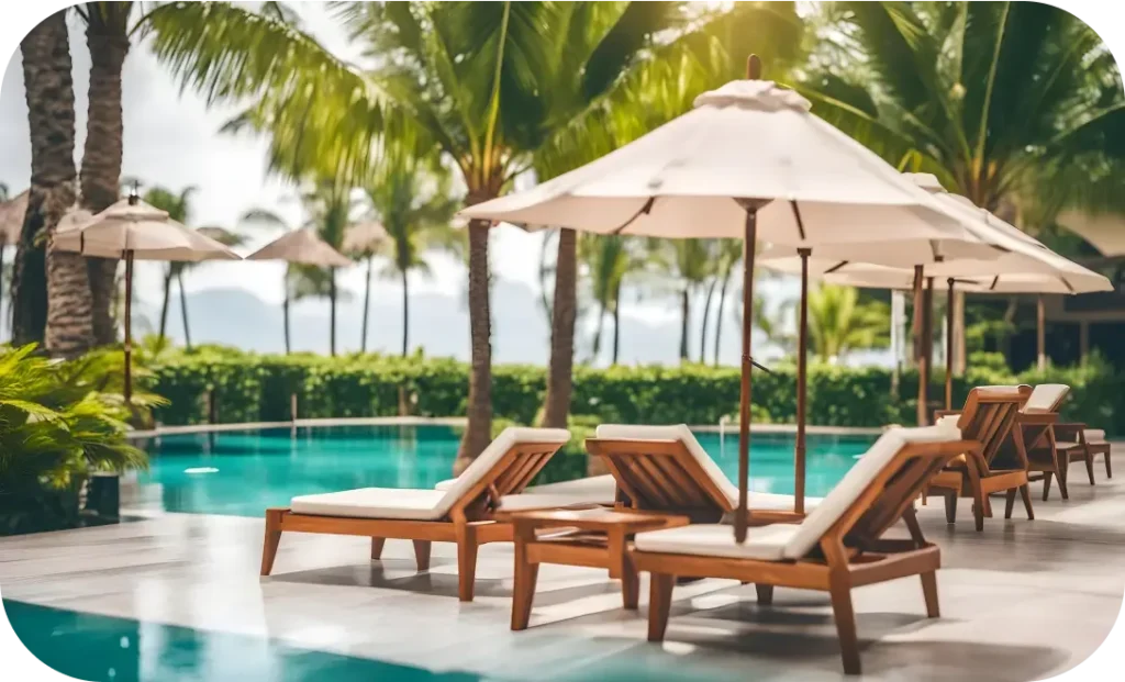 Poolside wicker loungers with umbrellas by Resort Wicker Furniture Manufacturer in India - Urbanland Products